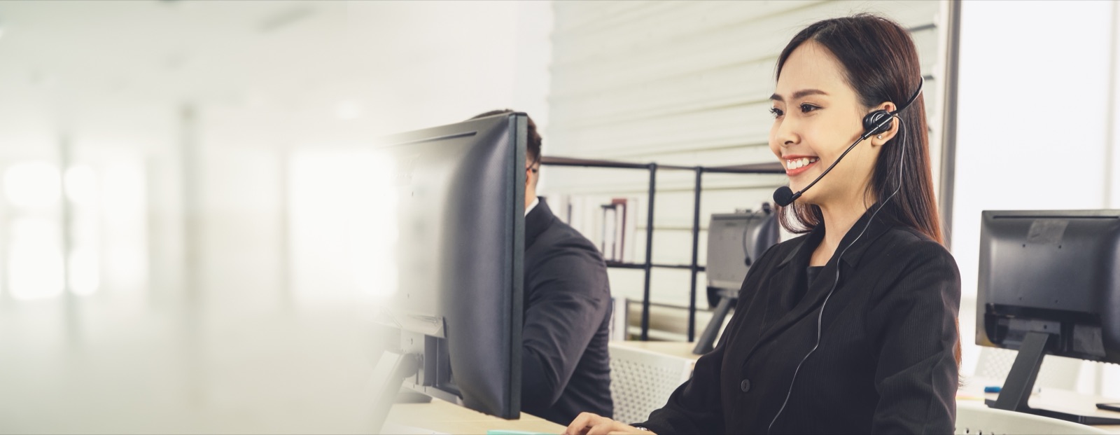 Support team members with headsets working at secure workstations